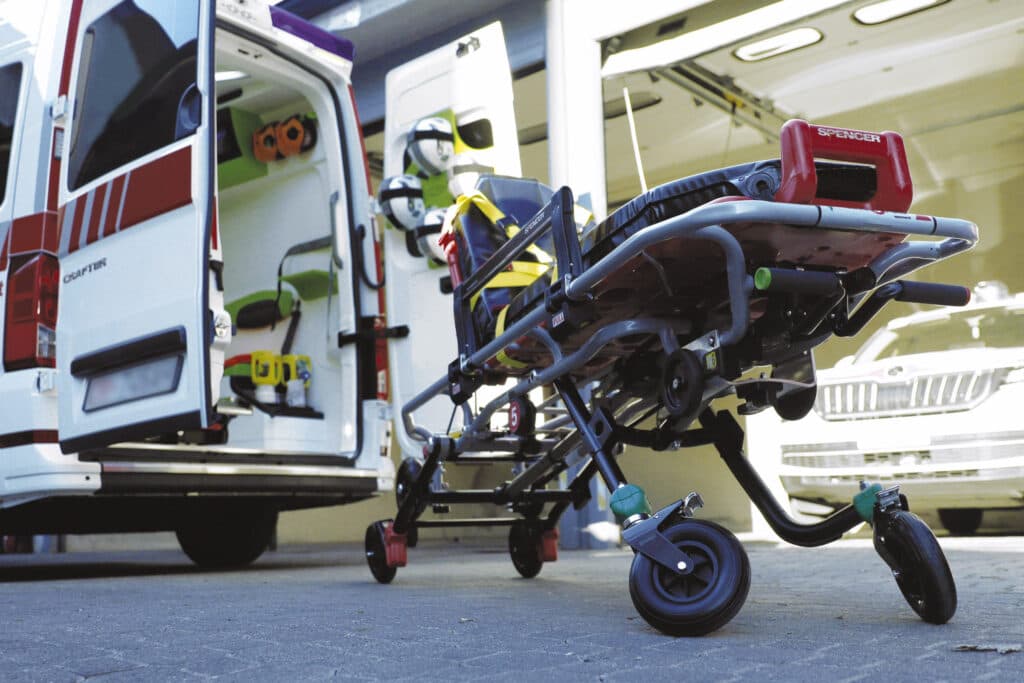 Self-loading stretcher Cinco Mas near ambulance